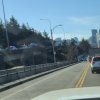 car high-centered on overpass guardrail.jpg