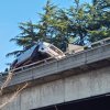car high-centered on overpass guardrail1.jpg