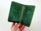 green wallet hand holding.jpg
