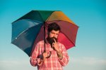 lgbt-man-with-rainbow-umbrella-long-hair-beard-gay-pride-lgbtq-concept-isolated-sky_265223-17285.jpg