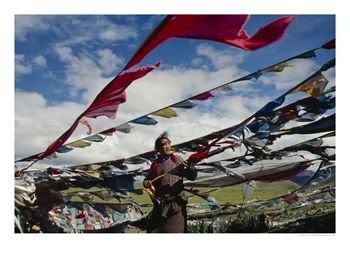 Pilgrim-Hoists-Prayer-Flags-Over-a-.jpg